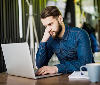 Businessman using laptop editing a PDF